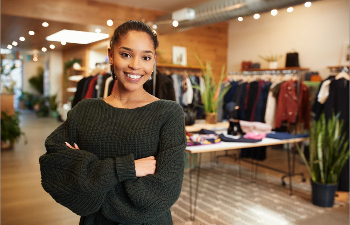 young business owner poses in her shop